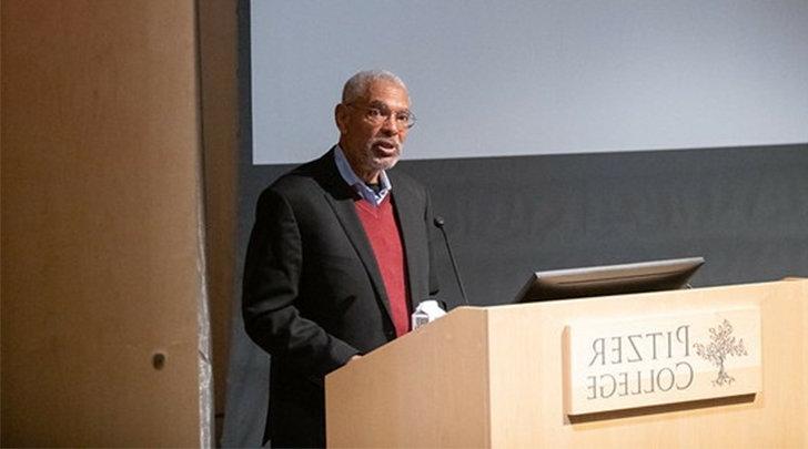 Melvin L. Oliver stands at the podium in Pitzer's Benson auditorium.